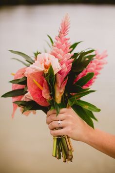 a person holding a bouquet of flowers in their hand