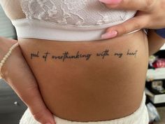 a woman with a tattoo on her stomach saying, god of everything with my heart