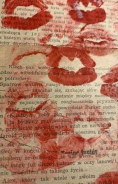 an old book with red lipstick on it and some words written in the bottom right corner