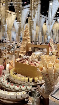 a table filled with lots of desserts and pastries on top of each other