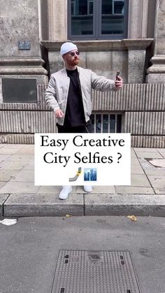 a man standing in front of a building holding a sign that says easy creative city selfies?