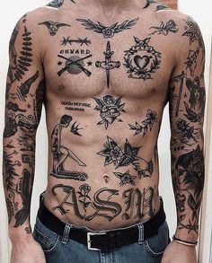 a man with lots of tattoos on his body and chest standing in front of a cactus