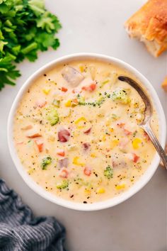 a white bowl filled with soup next to bread