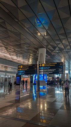 people are walking through an airport terminal