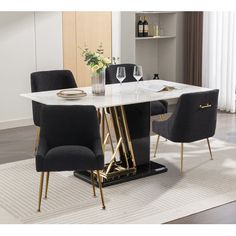 a dining room table with black chairs and a white rug