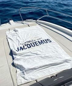 a white t - shirt that says twice of jacquemus on the back of a boat