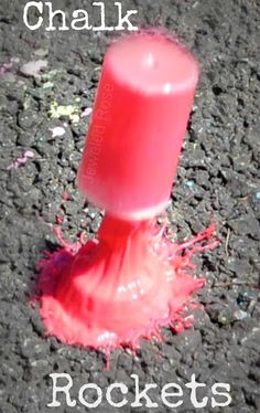 a red candle sitting on top of a black ground next to the words chalk rocks