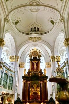 the inside of a church with gold and white decorations