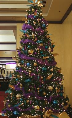 a christmas tree with purple and gold decorations