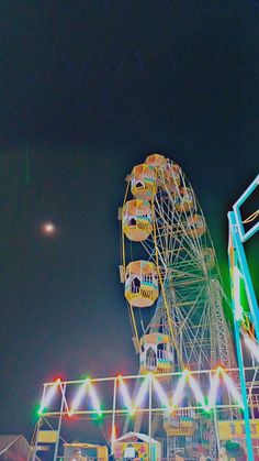 an amusement park at night with ferris wheel in the foreground and bright lights on the ground