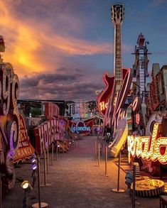 an assortment of neon signs and guitars on display