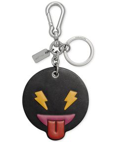 a keychain with a smiley face and lightning bolt on it's side