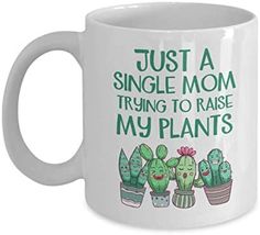 a white coffee mug that says, just a single mom trying to raise my plants