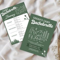 two camping camp bachelor party cards on a bed with white sheets and greenery in the background