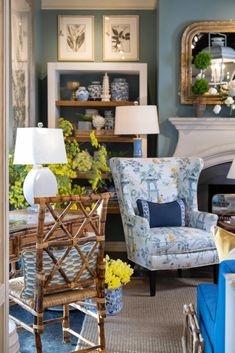 a living room filled with lots of furniture and flowers in vases on the table