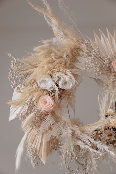 two wreaths made out of feathers and flowers