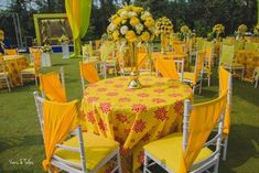 tables and chairs are set up with yellow linens