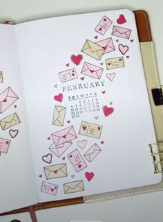 an open planner with hearts and envelopes on it