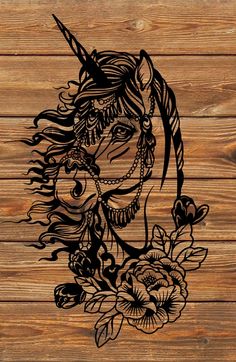 a drawing of a unicorn with flowers on a wooden background