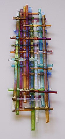 a multicolored wall hanging made out of toothbrushes