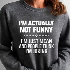 a woman wearing a sweatshirt that says, i'm actually not funny and i'm just mean and people think i'm joking