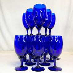 a group of blue wine glasses sitting on top of each other