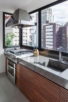 a kitchen with a stove top oven next to a window and a sink in front of it