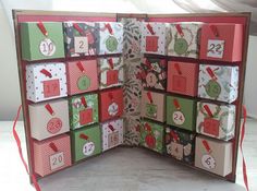 an open christmas card box with lots of cards on the front and sides, all decorated in different colors