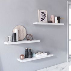 two white shelves with various items on them