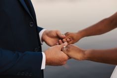 the bride and groom are holding hands together