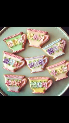 decorated cookies in the shape of tea cups and flowers