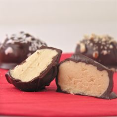 several pieces of chocolate covered candy on a red napkin