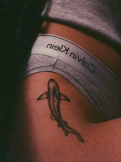 a woman's stomach with a tattoo on it that reads calvin klein