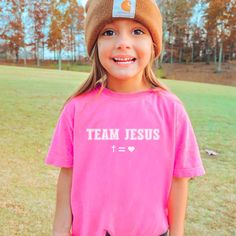 Christian Kids Shirt, Team Jesus Shirt, Cross Equals Love Comfort Colors Kids Tees, Christian Shirts for Kid, Christian Gift Children Youth Created to fit in any kid's active schedule, these kid's tee shirts pack both comfort and agility. Made 100% with combed ring-spun cotton for total comfort whether it's studying or playing time. The fabric is soft-washed and garment-dyed. Meanwhile, the classic fit makes it the perfect choice for day-long wear.  .: 100% combed ringspun cotton .:  Medium fabric (6.1 oz/yd² (206.8 g/m .: Classic Fit .: Sew-in twill label .: Direct to Garment Printing - NO VINYL is used ✦ SIZING ✦ ✿ Please refer to the size chart in the photo section for shirt measurements to ensure you order the size you desire.  ✦ CARE INSTRUCTIONS ✦ ✿ Machine wash on cold, inside-out, Pink Short Sleeve Family Matching Shirt, Family Matching Pre-shrunk Pink Tops, Pink Family Matching Shirt With Letter Print, Pink Crew Neck Shirt For Family Matching, Pink Short Sleeve Shirt With Name Print, Cross Equals Love, Christian Kids Shirts, Kids Tee Shirts, Kids Tees