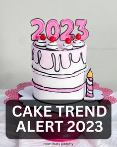 a white cake with pink frosting and two candles on top that says 2055 cake trend alert