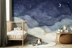 a baby's room with a night sky mural