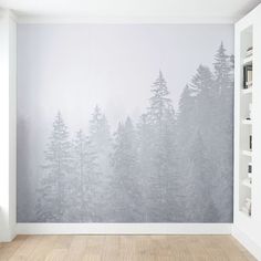 an empty room with a large wall mural in the middle and lots of trees on it