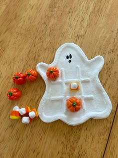 a plastic halloween ghost with candy on the floor