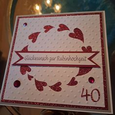 a close up of a greeting card on a glass table with lights in the background