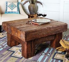 a wooden table sitting on top of a rug