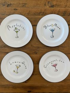 four white plates with different designs on them