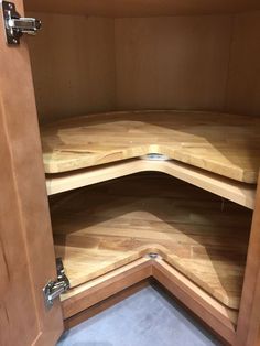 the corner of a wooden cabinet with metal handles