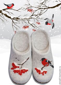 a pair of slippers sitting on top of a snow covered ground next to a tree