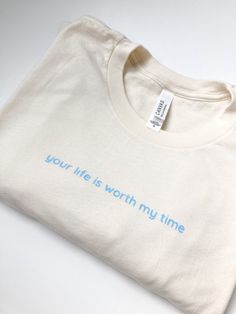 "Tshirt reads \"Your life is worth my time\", perfect for any nurse, medical professional, or those working in mental health.  This shirt is comfortable to wear and stylish, making it the perfect addition to your wardrobe while stressing an important message" Relaxed Fit T-shirt With Meaningful Text Print, Relaxed Fit T-shirt With Quote Print For Everyday, Meaningful Quote Print Crew Neck T-shirt, Crew Neck Cotton Shirt With Quote Print, Cotton Crew Neck Shirt With Quote Print, Inspirational Text Print T-shirt For Everyday, Cotton T-shirt With Quote Print, Relaxed Fit, Relaxed Fit Cotton T-shirt With Quote Print, Inspirational Crew Neck T-shirt For Everyday