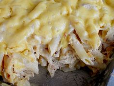 a casserole dish with chicken and cheese on top