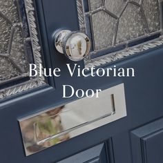 the blue victorian door has a glass paneled window