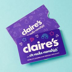 a pair of business cards sitting on top of a blue surface with hearts and stars