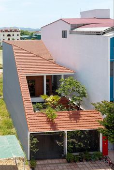 an aerial view of a house with red tiled roof