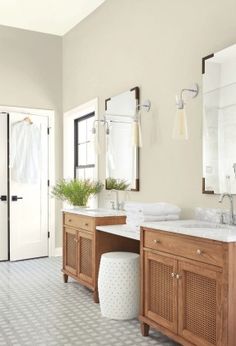 a bathroom with two sinks and mirrors in it