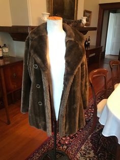 "Stunning 70s faux fur coat to dress up or down. Two pockets and double-breasted closure. Hooks together with loops and hooks. The buttons are a deep bronze and the fluffy collar will keep you warm on the coldest of days. Wear with jeans or dressed up for an evening out. No flaws. Can accommodate a range of sizes.  Measurements: Bust: 19\" Waist: 18\" Hip: 23\"" Retro Faux Fur Outerwear For Fall, Retro Outerwear With Faux Fur Lining, Vintage Long Sleeve Fur Coat With Faux Fur Lining, Vintage Faux Fur Trim Coat For Fall, Retro Fall Fur Coat With Faux Fur Lining, Retro Fur Coat With Faux Fur Lining For Fall, Retro Faux Fur Lined Coat For Fall, Vintage Long-sleeved Faux Fur Coat, Vintage Fur Coat With Faux Fur Lining For Fall